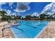 Enjoy a large swimming pool with clear blue water, surrounded by palm trees and lounge chairs, perfect for relaxation at 5830 100Th E Ave, Parrish, FL 34219