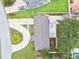 An aerial view of house rooftops and green yards with neighborhood swimming pools on a sunny day at 5934 51St N Ave, Kenneth City, FL 33709