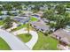 A single-story home featuring a circular driveway and mature trees, situated in a neighborhood with backyard pools at 5934 51St N Ave, Kenneth City, FL 33709