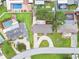 An aerial view of rooftops of houses and green yards with neighborhood swimming pools on a sunny day at 5934 51St N Ave, Kenneth City, FL 33709