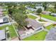A single-story home featuring a circular driveway, mature trees, a fenced backyard, and a detached storage shed at 5934 51St N Ave, Kenneth City, FL 33709