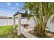 Landscaped backyard with pergola, featuring lush greenery, a pathway, and privacy fencing for relaxation at 5934 51St N Ave, Kenneth City, FL 33709