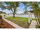 Expansive backyard featuring lush green grass, privacy fencing, and a storage shed, ideal for outdoor activities at 5934 51St N Ave, Kenneth City, FL 33709