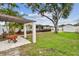 Spacious backyard with a pergola, mature trees, and a well-maintained lawn, offering a serene outdoor space at 5934 51St N Ave, Kenneth City, FL 33709
