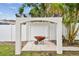 Backyard featuring a brick pergola with a wheelbarrow at 5934 51St N Ave, Kenneth City, FL 33709