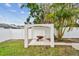 Backyard featuring a brick pergola with a wheelbarrow, offering charm and garden appeal at 5934 51St N Ave, Kenneth City, FL 33709