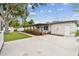 View of the backyard, with a patio, driveway, and a detached garage at 5934 51St N Ave, Kenneth City, FL 33709