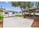 A backyard with a shed, patio area, and privacy fence offers outdoor living and storage at 5934 51St N Ave, Kenneth City, FL 33709