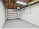 Unfinished basement features painted walls and floor, plus a garage door at 5934 51St N Ave, Kenneth City, FL 33709