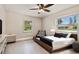 Bright bedroom with neutral tones, stylish bed, and two windows at 5934 51St N Ave, Kenneth City, FL 33709