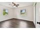 Vacant bedroom with hardwood floors, white walls, and windows at 5934 51St N Ave, Kenneth City, FL 33709