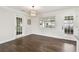 Dining area features hardwood floors, neutral walls and updated modern light fixture at 5934 51St N Ave, Kenneth City, FL 33709