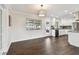 A dining room featuring hardwood floors, neutral walls and an updated modern light fixture at 5934 51St N Ave, Kenneth City, FL 33709