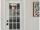 This view looks through a window-paneled door to a bright and modern kitchen at 5934 51St N Ave, Kenneth City, FL 33709