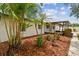 Charming exterior with a covered porch, fresh mulch, and a well-manicured garden showcasing curb appeal at 5934 51St N Ave, Kenneth City, FL 33709
