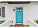 Close-up of home's bright blue front door with glass pane and brick tiled entrance at 5934 51St N Ave, Kenneth City, FL 33709