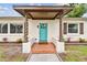 Close-up of home's entrance featuring twisted columns and a vibrant blue front door at 5934 51St N Ave, Kenneth City, FL 33709