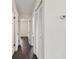 Hallway with dark wood floors, white walls, and closet with louvered doors at 5934 51St N Ave, Kenneth City, FL 33709