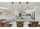 Island kitchen featuring an island with bar stool seating, modern lighting and stainless appliances at 5934 51St N Ave, Kenneth City, FL 33709
