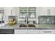 Close-up of the stylish kitchen sink featuring a stainless steel sink and modern faucet with a lovely backsplash at 5934 51St N Ave, Kenneth City, FL 33709