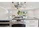 Open kitchen with stainless steel oven, sleek countertops and pendant lighting fixtures at 5934 51St N Ave, Kenneth City, FL 33709
