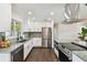 Bright kitchen featuring white cabinets, stainless steel appliances, and beautiful countertop with island at 5934 51St N Ave, Kenneth City, FL 33709