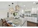 A modern, updated kitchen with a gray marble counter and stainless steel appliances at 5934 51St N Ave, Kenneth City, FL 33709