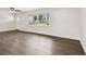 Bright living room featuring wood floors and natural light from large windows at 5934 51St N Ave, Kenneth City, FL 33709
