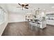 Open-concept living space with hardwood floors, kitchen island, pendant lights, and bright windows at 5934 51St N Ave, Kenneth City, FL 33709