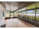 Screened patio with tile flooring and views of the private, fenced backyard at 5934 51St N Ave, Kenneth City, FL 33709