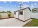 Exterior view of backyard shed with concrete foundation and neutral paint at 5934 51St N Ave, Kenneth City, FL 33709