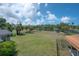 Spacious backyard with a large grassy area and views of the canal, perfect for outdoor activities and relaxation at 6108 Oak Ridge Ave, New Port Richey, FL 34653