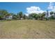 Vast backyard featuring well-maintained grass and a view of the house, ideal for outdoor entertaining and recreation at 6108 Oak Ridge Ave, New Port Richey, FL 34653