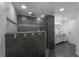 Bathroom boasts a modern shower, gray tile, and stone accents at 6108 Oak Ridge Ave, New Port Richey, FL 34653