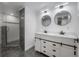 Bathroom boasts double vanity and a modern shower with stone accents at 6108 Oak Ridge Ave, New Port Richey, FL 34653