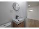 Modern half bath with a square sink, wooden vanity, and updated faucet at 6108 Oak Ridge Ave, New Port Richey, FL 34653