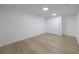 Bright bedroom featuring light hardwood floors and a large sliding-door closet at 6108 Oak Ridge Ave, New Port Richey, FL 34653