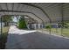 Under the carport offering shelter for vehicles alongside backyard and outdoor living spaces at 6108 Oak Ridge Ave, New Port Richey, FL 34653