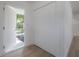 Entryway featuring a white door, closet and light hardwood floors at 6108 Oak Ridge Ave, New Port Richey, FL 34653