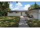 Beautiful home featuring fresh landscaping and a quaint covered outdoor deck at 6108 Oak Ridge Ave, New Port Richey, FL 34653