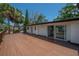 Home's exterior featuring a large wooden deck, perfect for outdoor gatherings at 6108 Oak Ridge Ave, New Port Richey, FL 34653