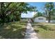 Charming one-story home featuring a well-manicured lawn and inviting walkway at 6108 Oak Ridge Ave, New Port Richey, FL 34653