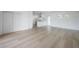 Spacious living room with hardwood flooring, white walls, and access to the kitchen at 6108 Oak Ridge Ave, New Port Richey, FL 34653