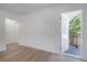 Light filled living room, with an open door, and light hardwood floors at 6108 Oak Ridge Ave, New Port Richey, FL 34653
