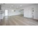 Bright living room with hardwood flooring, white walls, and recessed lighting fixtures at 6108 Oak Ridge Ave, New Port Richey, FL 34653