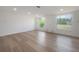 Living room featuring light hardwood floors, and multiple windows with views at 6108 Oak Ridge Ave, New Port Richey, FL 34653