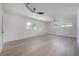 Spacious main bedroom with hardwood floors, two ceiling fans, and abundant natural light at 6108 Oak Ridge Ave, New Port Richey, FL 34653