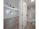 Bright main bedroom with hardwood floors adjoins a bathroom with glass enclosed shower at 6108 Oak Ridge Ave, New Port Richey, FL 34653