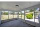 Enclosed porch with views of a well-maintained yard and scenic surroundings for relaxing outdoors at 6108 Oak Ridge Ave, New Port Richey, FL 34653