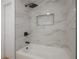 Modern shower with white and brown marble tile, and black fixtures at 6108 Oak Ridge Ave, New Port Richey, FL 34653